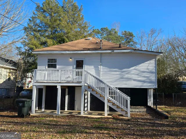 a view of a house with a yard balcony and furniture