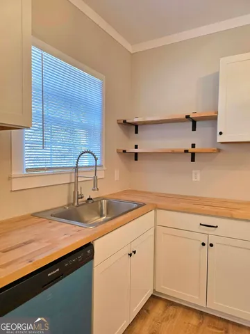 a kitchen with cabinets appliances and a sink