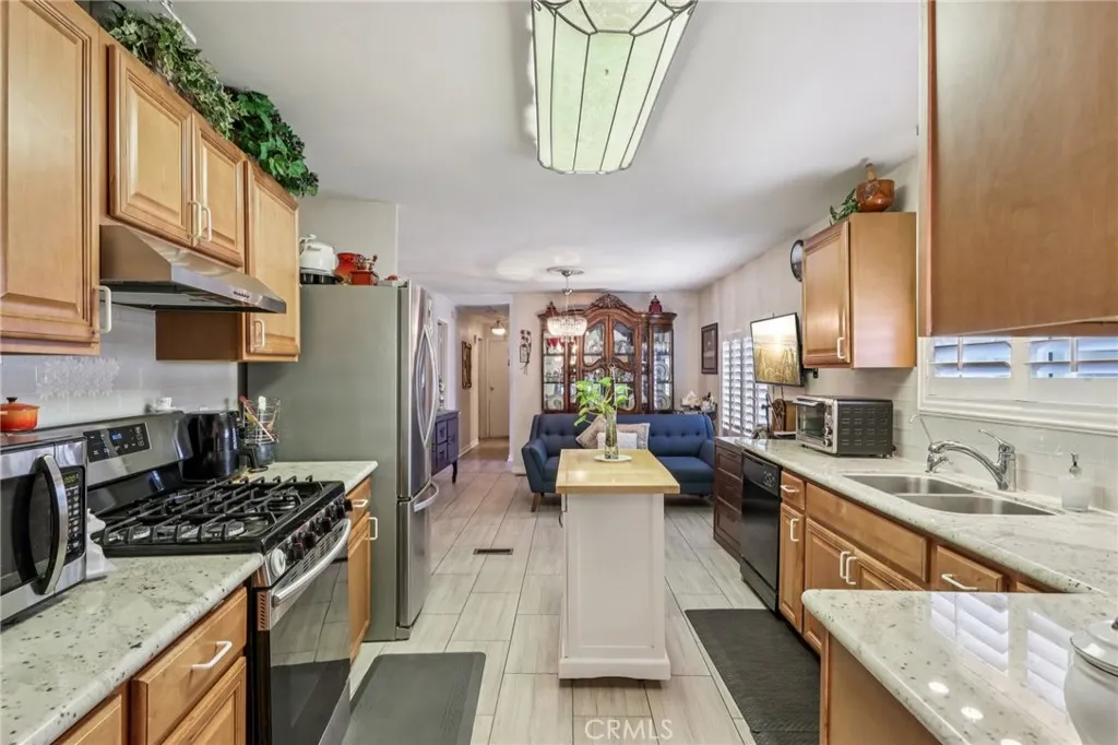 3700 Buchanan Street, Unit 28 Riverside, CA 92503 - Photo 14 of 35 a kitchen with stainless steel appliances granite countertop a sink stove and refrigerator