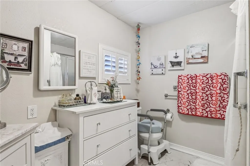 3700 Buchanan Street, Unit 28 Riverside, CA 92503 - Photo 30 of 35 a bathroom with a sink toilet and mirror