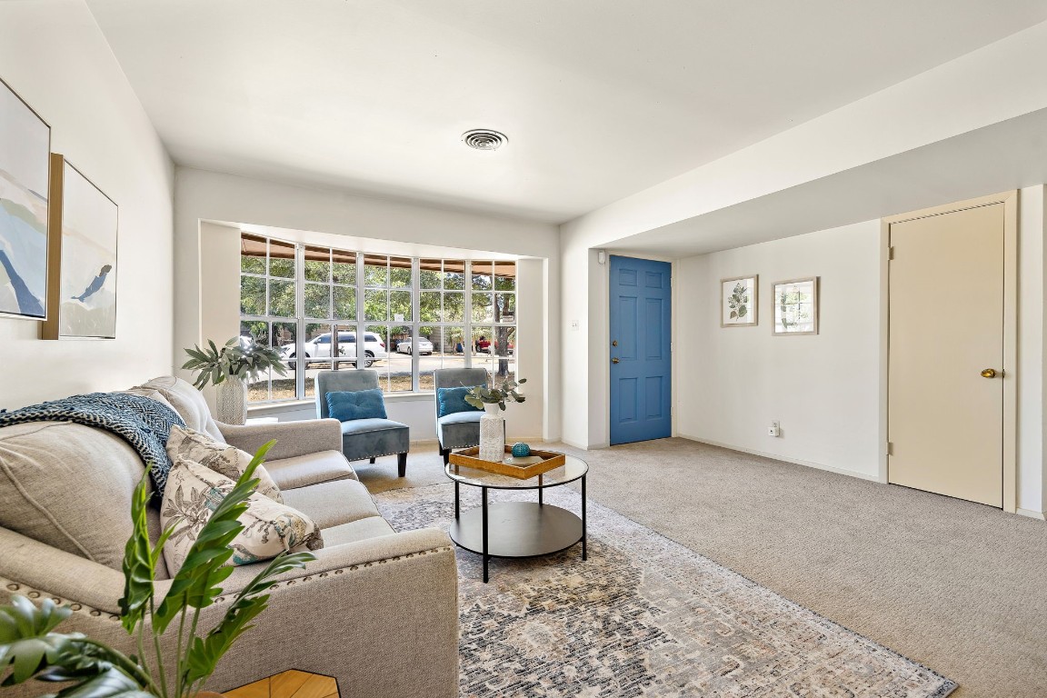a living room with furniture and a large window