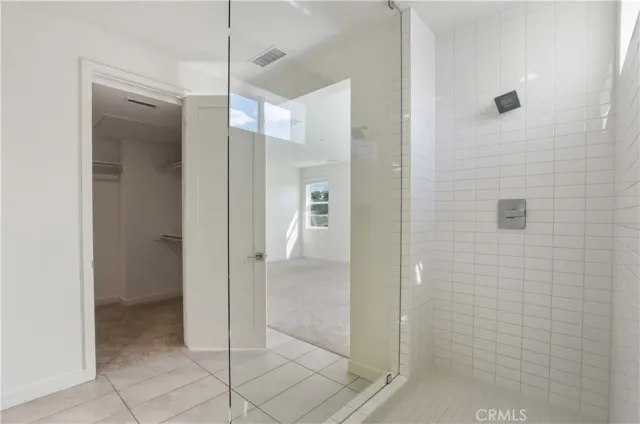 a spacious bathroom with a granite countertop sink a mirror and a shower