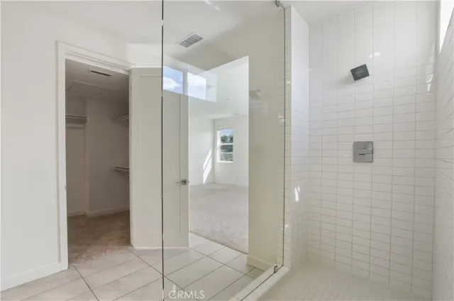 a spacious bathroom with a granite countertop sink a mirror and a shower