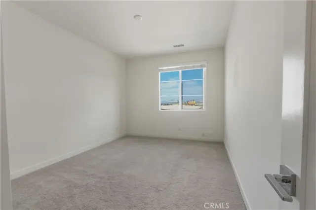 an empty room with closet area