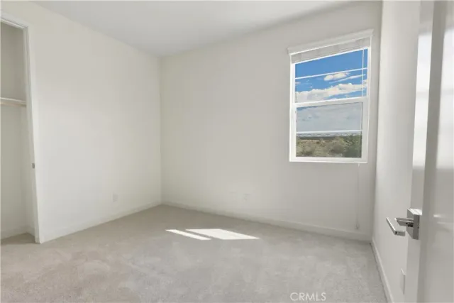 a view of an empty room and a bathroom