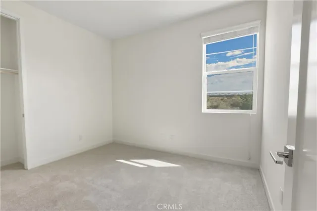 a view of an empty room and a bathroom