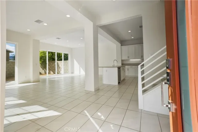 a view of kitchen with furniture and refrigerator