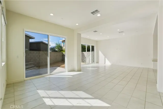 a view of a hallway with wooden floor and entryway