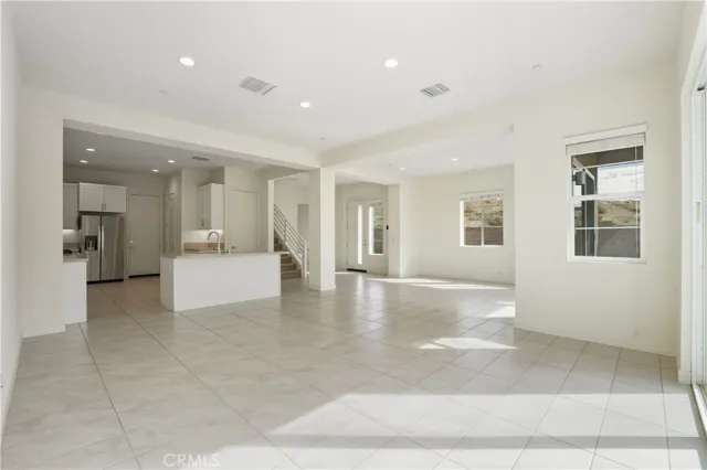 a kitchen with stainless steel appliances a refrigerator sink and microwave