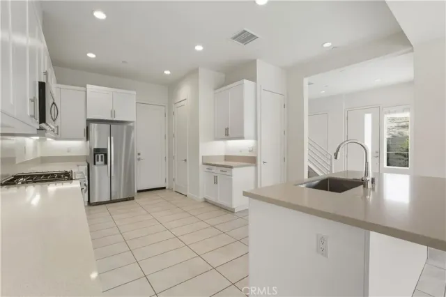 a kitchen with a sink window and cabinets