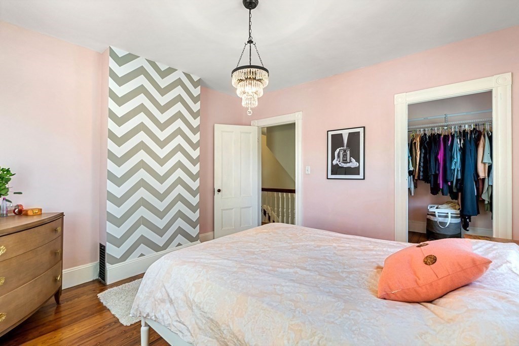 11 Hadwin Way Boston, MA 02131 - Photo 16 of 22 a bedroom with a bed and a chandelier