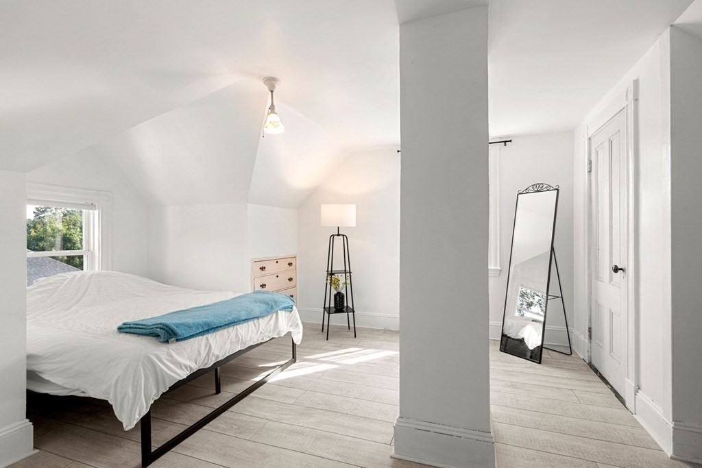 11 Hadwin Way Boston, MA 02131 - Photo 17 of 22 a bedroom with a bed and a chandelier