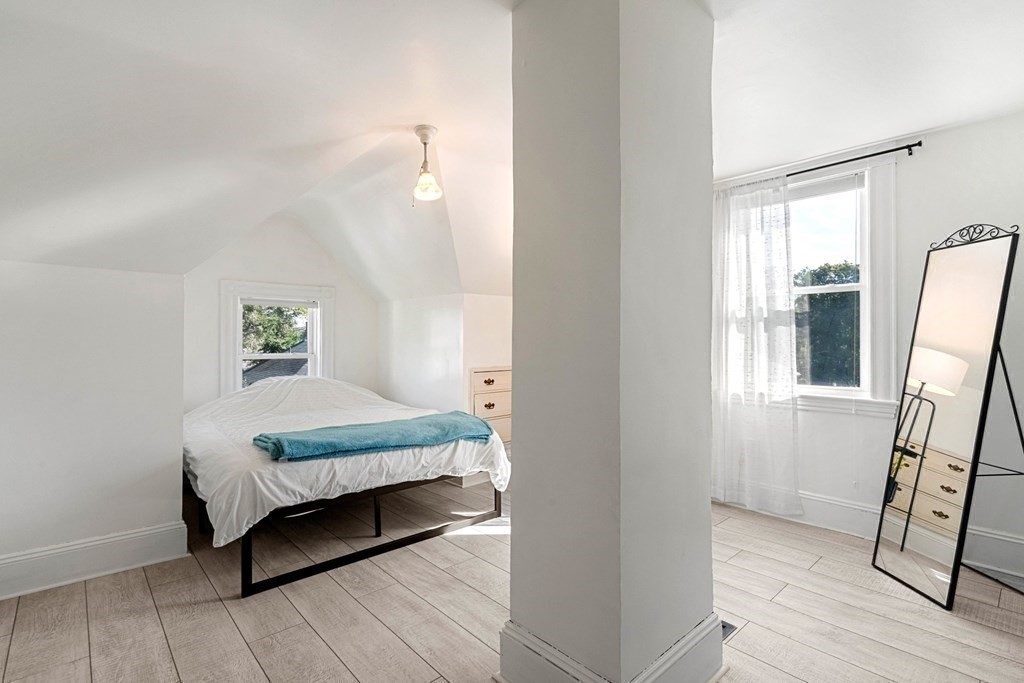 11 Hadwin Way Boston, MA 02131 - Photo 18 of 22 a bedroom with a bed and wooden floor