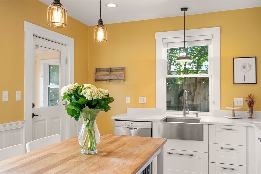 11 Hadwin Way Boston, MA 02131 - Photo 4 of 22 a vase of flowers sitting on a table with a chandelier