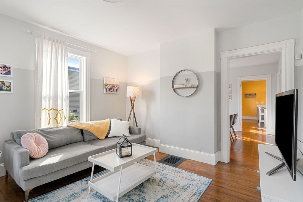 11 Hadwin Way Boston, MA 02131 - Photo 10 of 22 a living room with furniture a flat screen tv and a window