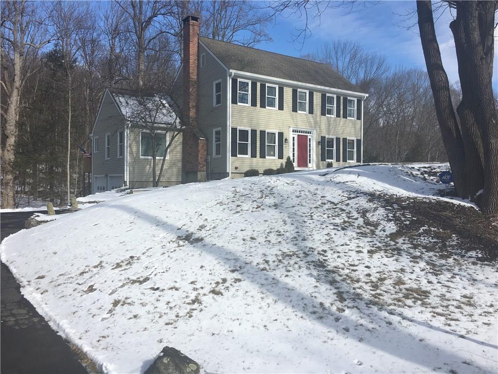 22 Whitlock Lane Ridgefield, CT 06877 - Photo 1 of 1 a front view of a house with a yard covered with snow