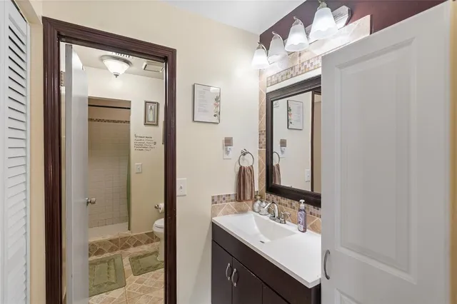 a bathroom with a sink vanity and a mirror