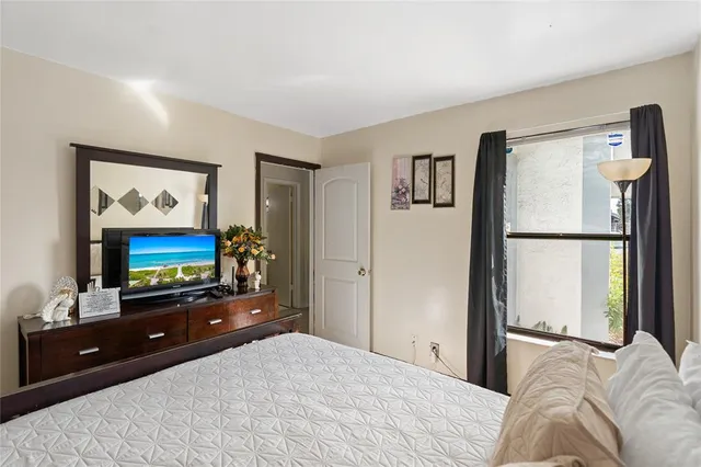 a bedroom with a bed and a flat screen tv
