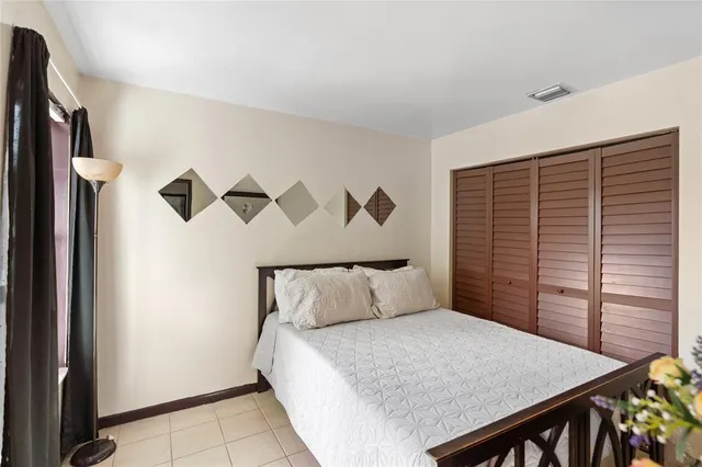 a bedroom with a bed and a night stand