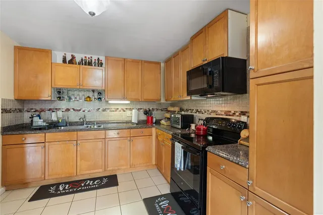a kitchen with stainless steel appliances granite countertop a stove sink and cabinets