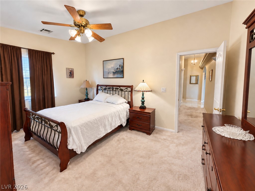 5470 Grain Mill Road Pahrump, NV 89061 - Photo 33 of 80 Secondary primary bedroom that has an attached bathroom with walk-in shower. Access to outside, enclosed patio as well. Soft carpeting pairs with neutral walls in this comfortable bedroom retreat.