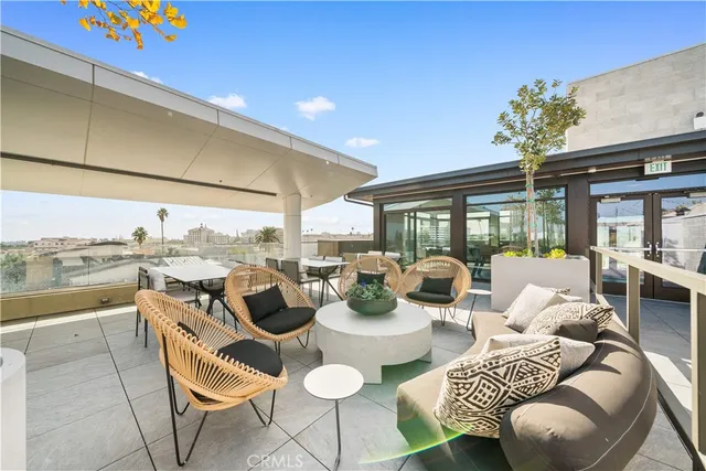 a living room with patio furniture and a potted plants