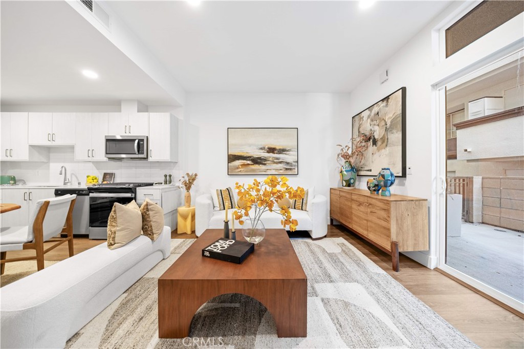 709 East Walnut Street, Unit 222 Pasadena, CA 91101 - Photo 4 of 46 a living room with furniture and wooden floor