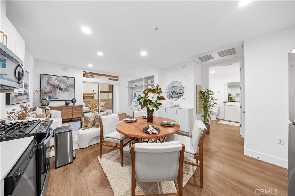 709 East Walnut Street, Unit 222 Pasadena, CA 91101 - Photo 5 of 46 a view of a dining room with furniture and wooden floor