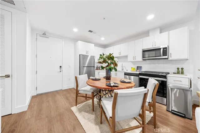 a view of a dining room with furniture and wooden floor