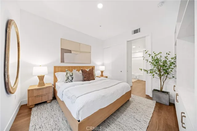 a bedroom with bed and a potted plant