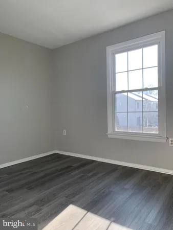 a view of wooden floor in an empty room