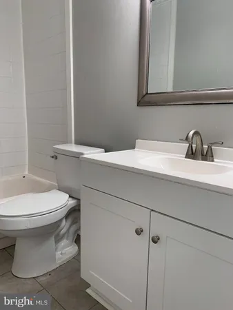 an empty room with wooden floor and window