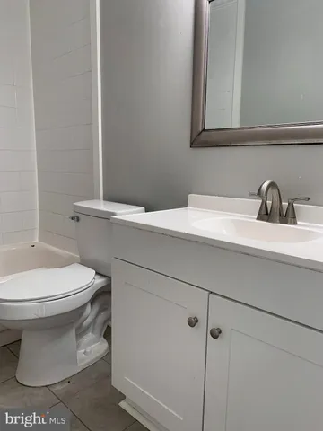 an empty room with wooden floor and window