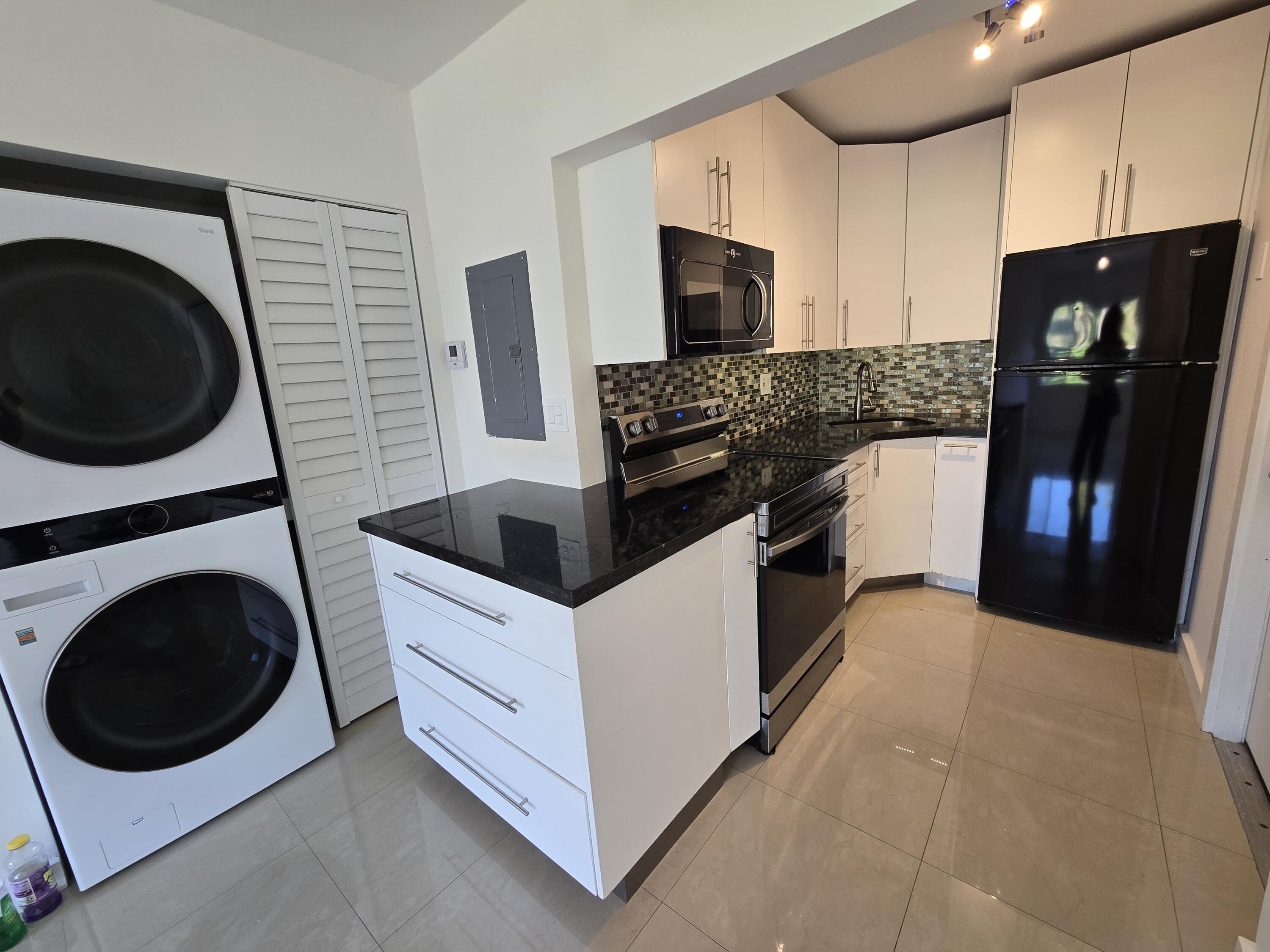 201 Southeast 6th Avenue, Unit 16 Pompano Beach, FL 33060 - Photo 4 of 10 a kitchen with a refrigerator sink and stove top oven