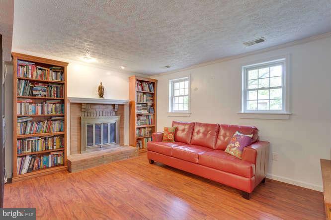 9522 Kirkfield Road Burke, VA 22015 - Photo 16 of 23 a living room with a couch and a book shelf