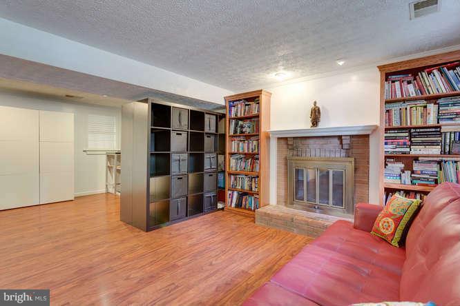 9522 Kirkfield Road Burke, VA 22015 - Photo 17 of 23 a spacious bedroom with a bed and a book shelf