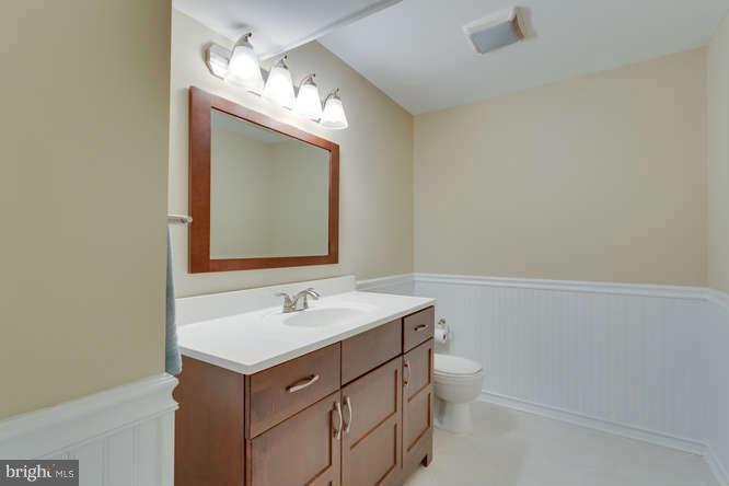 9522 Kirkfield Road Burke, VA 22015 - Photo 18 of 23 a bathroom with a sink a toilet and a mirror