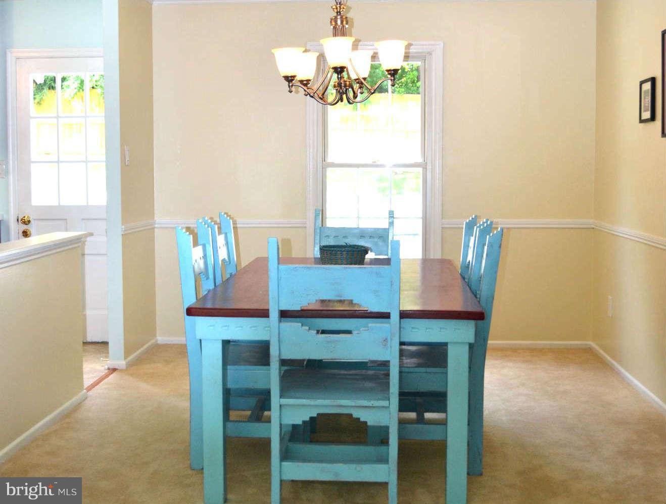 9522 Kirkfield Road Burke, VA 22015 - Photo 6 of 23 a dining room with furniture a window and wooden floor