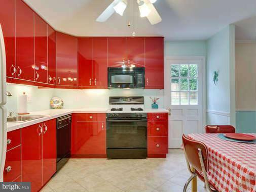9522 Kirkfield Road Burke, VA 22015 - Photo 9 of 23 a kitchen with stainless steel appliances granite countertop a stove a sink and a microwave