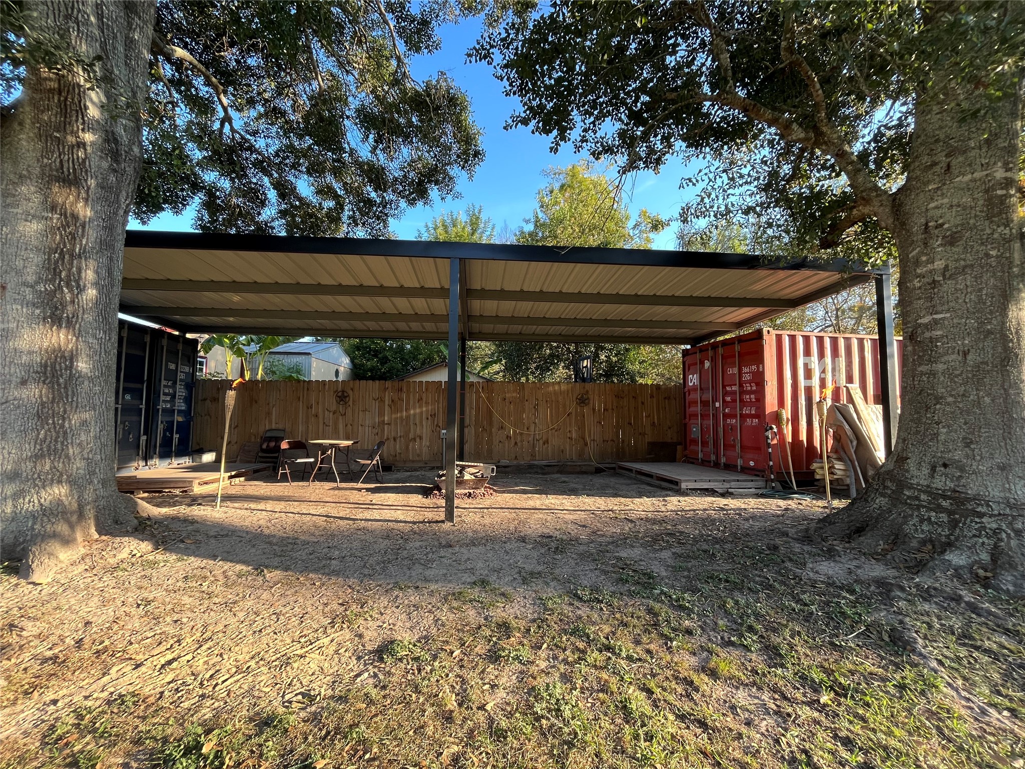 210 South Colbert Street Dayton, TX 77535 - Photo 14 of 14 a backyard of a house with barbeque oven table and chairs