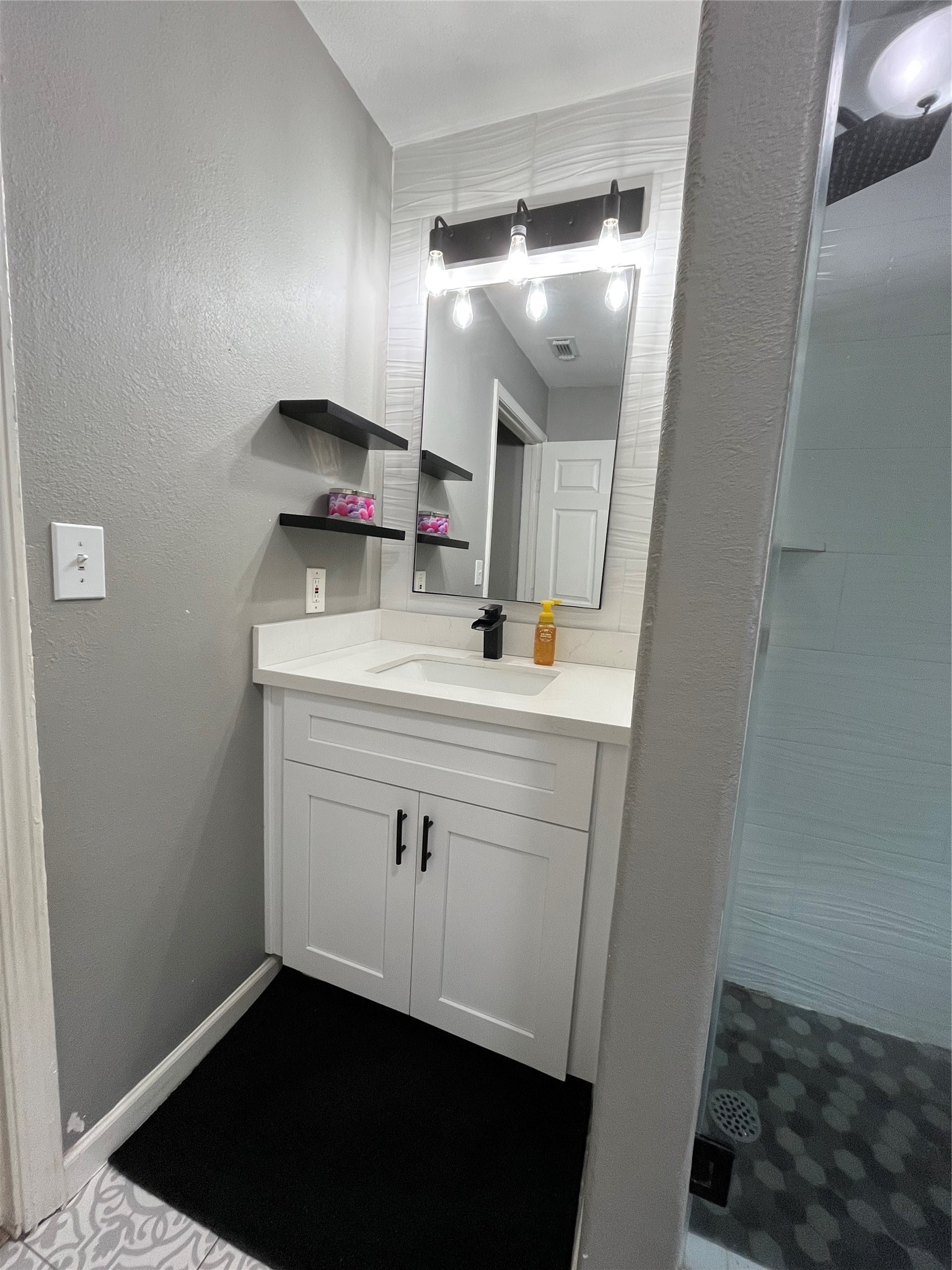 210 South Colbert Street Dayton, TX 77535 - Photo 2 of 14 a room with a sink vanity and mirror