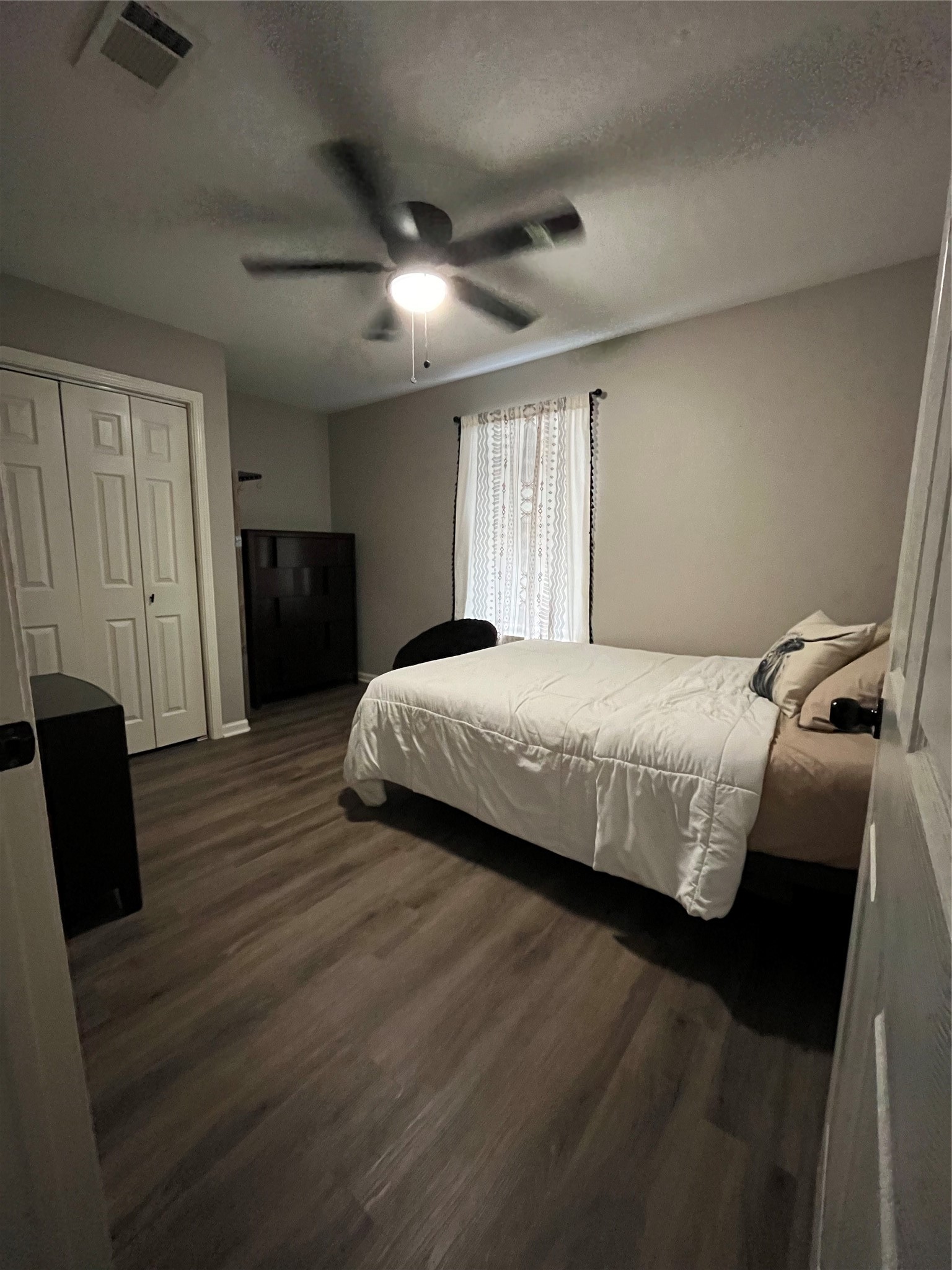 210 South Colbert Street Dayton, TX 77535 - Photo 5 of 14 a bedroom with a bed and a couch