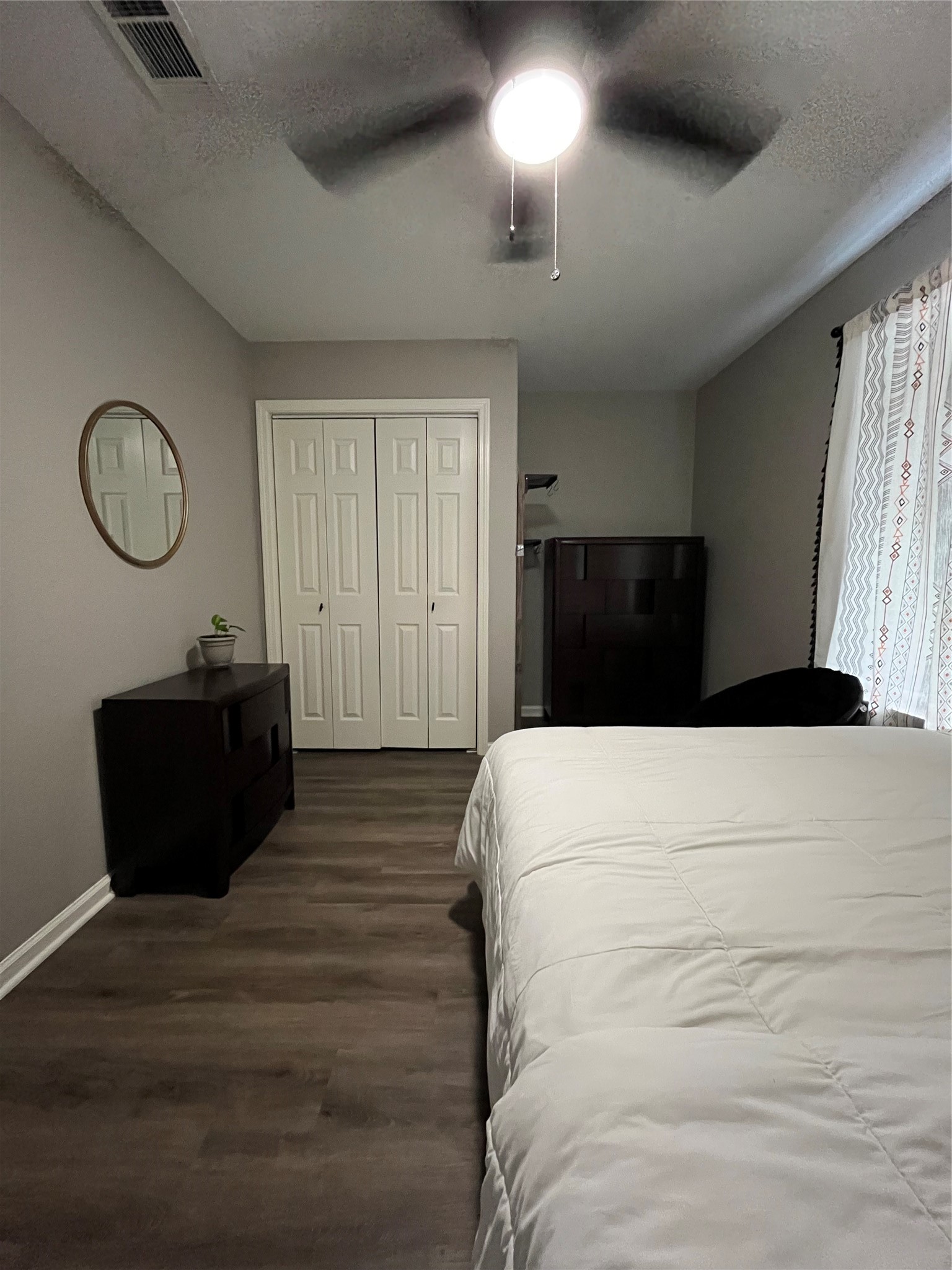 210 South Colbert Street Dayton, TX 77535 - Photo 6 of 14 a bed room with a bed mirror and a window