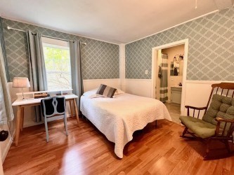 239 Pelham Road Amherst, MA 01002 - Photo 17 of 30 a bedroom with a bed and wooden floor