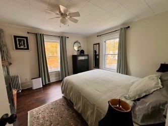 239 Pelham Road Amherst, MA 01002 - Photo 21 of 30 a bedroom with a bed and a chandelier