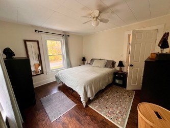 239 Pelham Road Amherst, MA 01002 - Photo 22 of 30 a bedroom with a bed window and a walk in closet