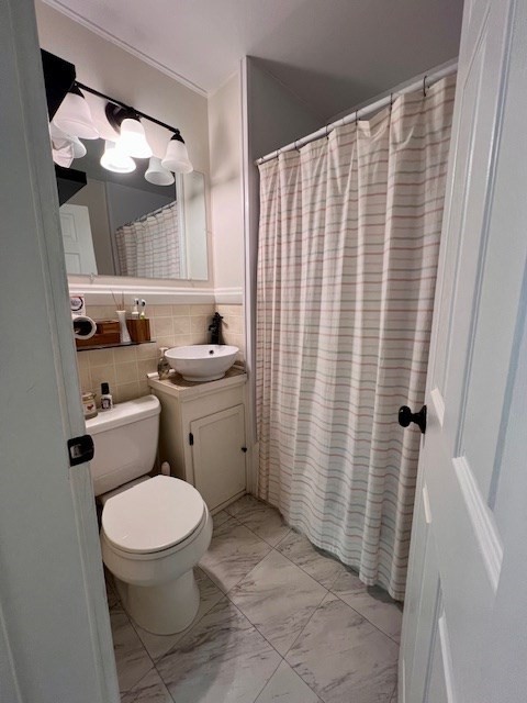 239 Pelham Road Amherst, MA 01002 - Photo 25 of 30 a bathroom with a sink a toilet a mirror and shower curtain