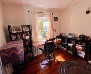 239 Pelham Road Amherst, MA 01002 - Photo 27 of 30 a living room with furniture and a book shelf