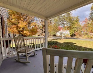 239 Pelham Road Amherst, MA 01002 - Photo 5 of 30 a balcony with wooden floor outdoor seating and city view