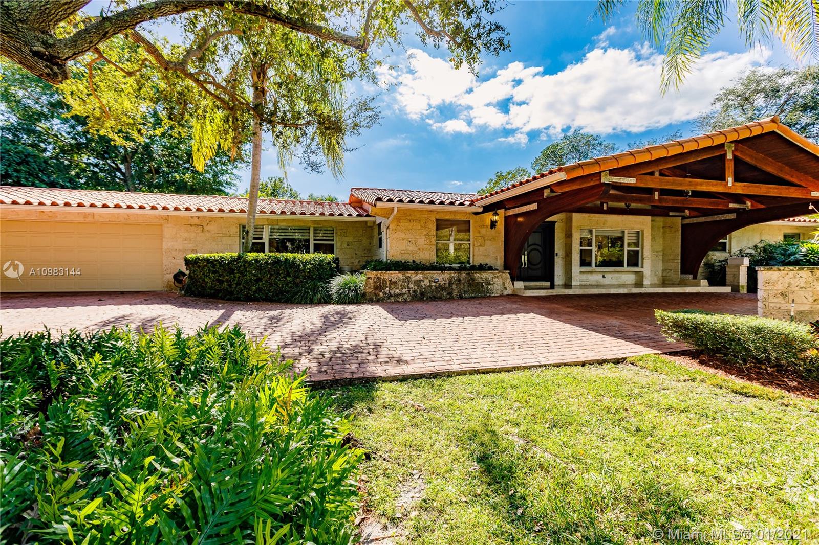 6400 Southwest 134th Drive Pinecrest, FL 33156 - Photo 2 of 50 a front view of a house with a yard and trees